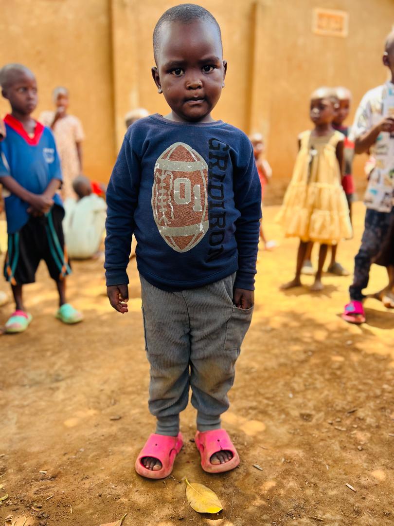 Young child standing in the community yard